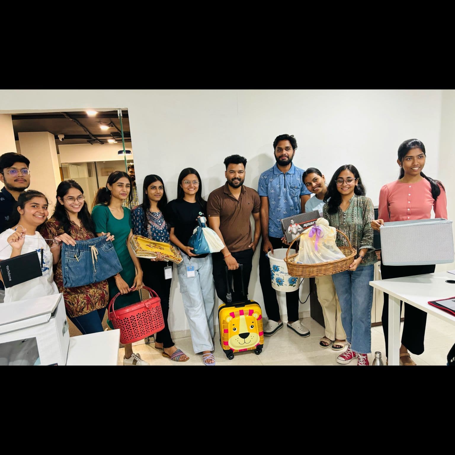 Team members celebrating with gifts at an office event